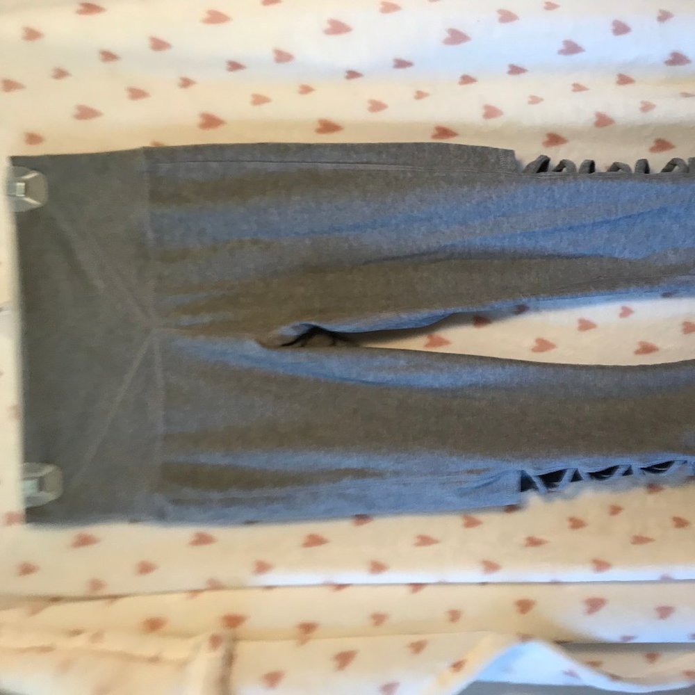 Grey yoga pants with open design on the outer calf